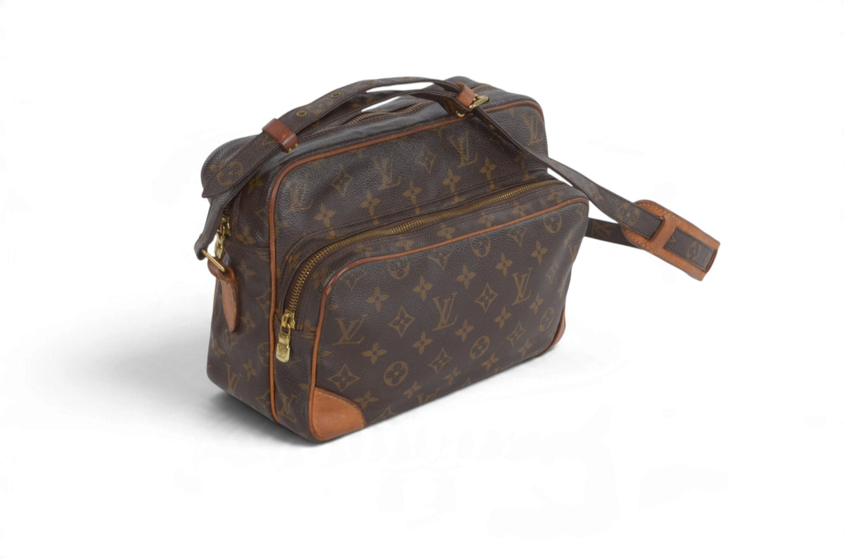 A Louis Vuitton monogram canvas shoulder bag with brown leather trim and gold-tone hardware, shown on a clean white background.