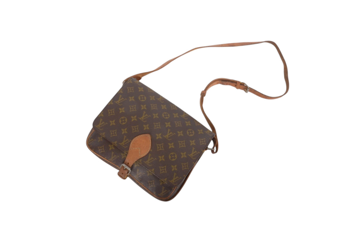 A Louis Vuitton monogram canvas shoulder bag in brown with a tan leather strap and front tab, shown on a plain white background.