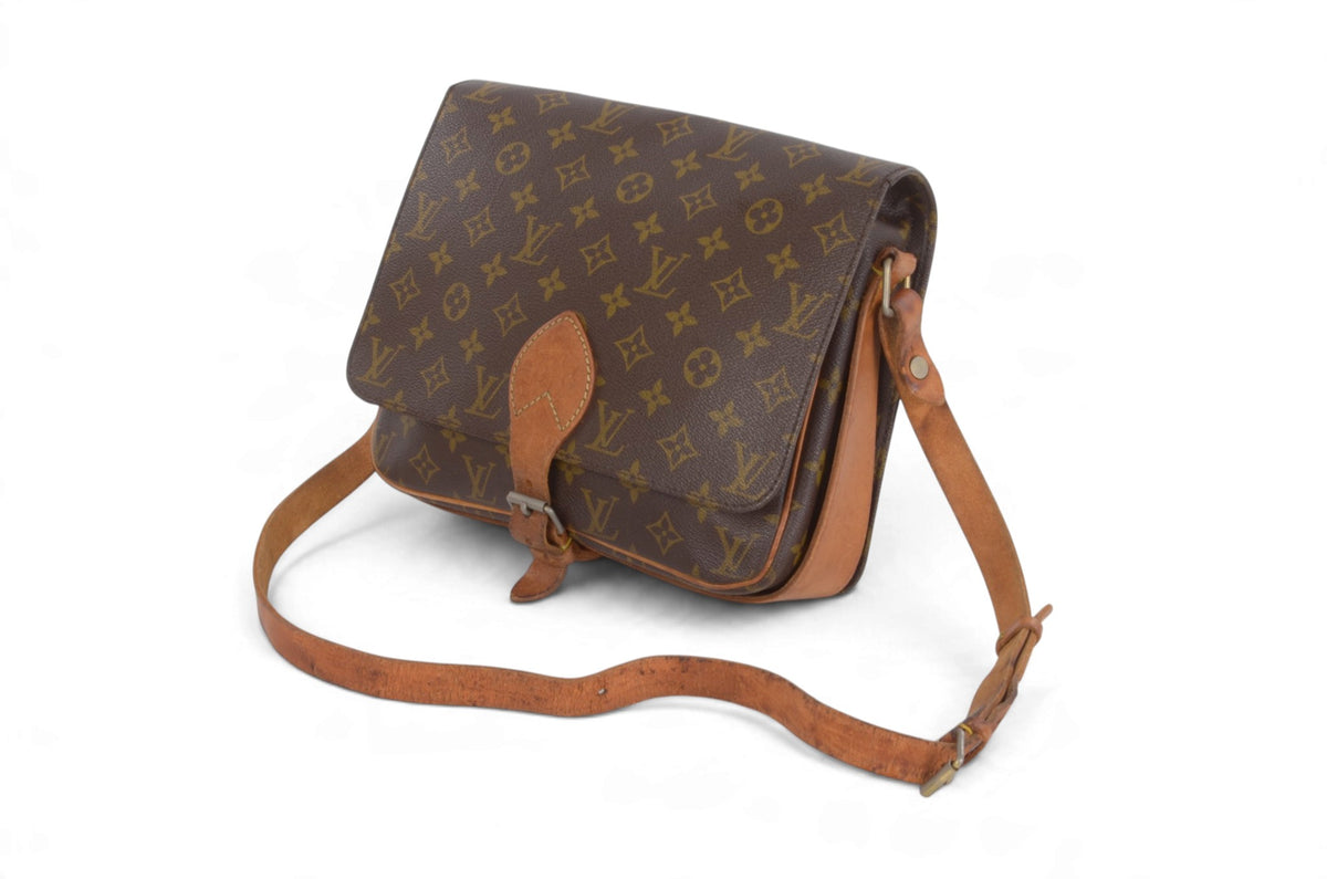 A Louis Vuitton monogram canvas shoulder bag with tan leather trim and strap, shown on a plain white background.