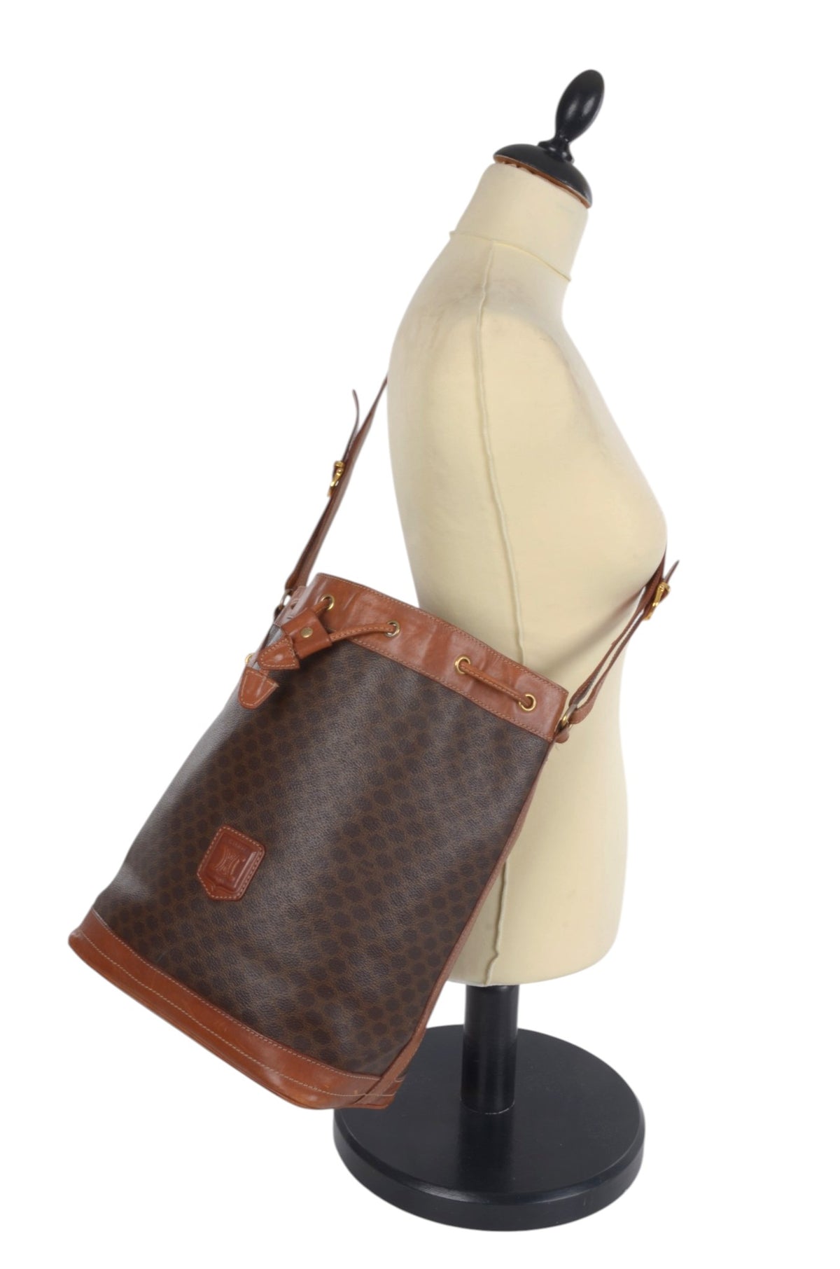 Vintage Celine monogram shoulder bag showing drawstring closure and leather trim